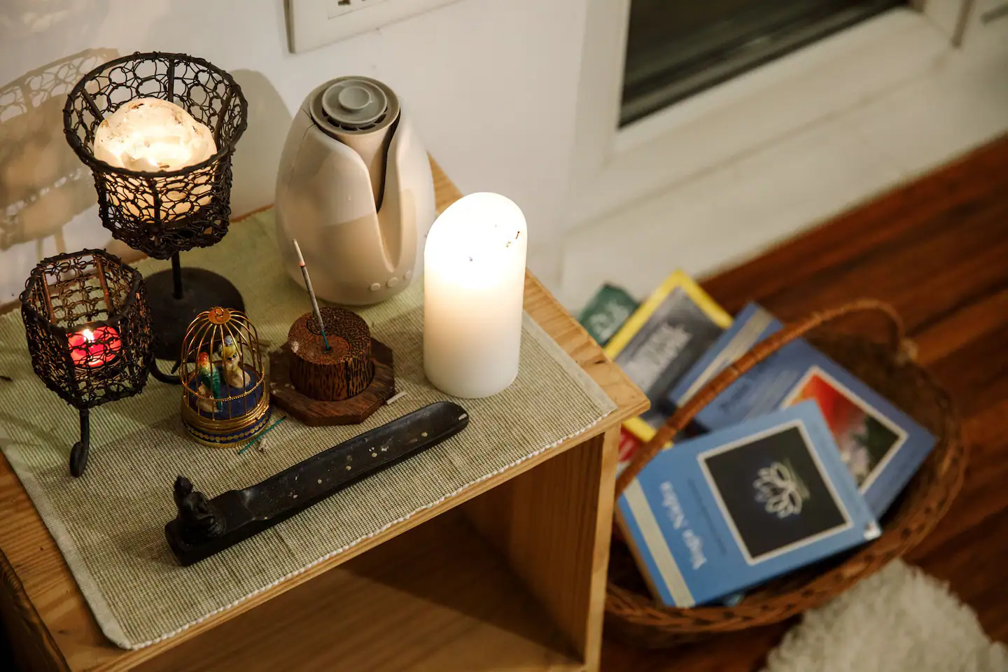 Bedside table with incense, salt lamp, and candles