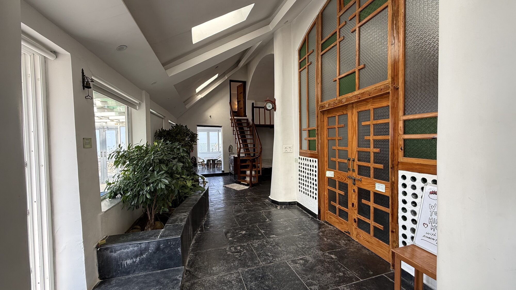 Earthship building exterior with rammed-earth walls and mountain backdrop