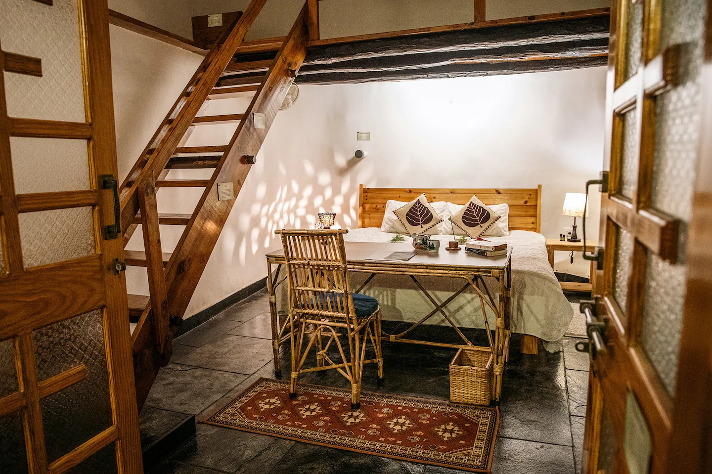 Cozy loft room with bamboo desk and ladder to upper level