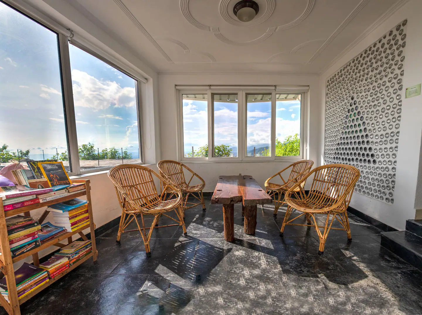 Sunroom reading area with mountain views and glass bottle wall